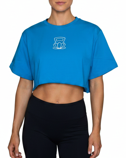 Woman wearing a blue crop top and black shorts on a white background