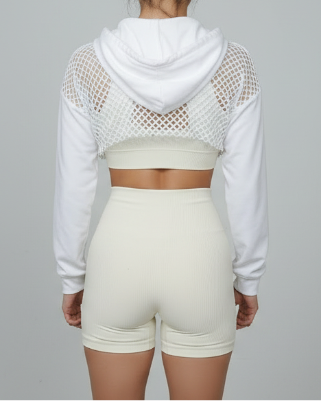 woman wearing a white cropped hoodie with a mesh back